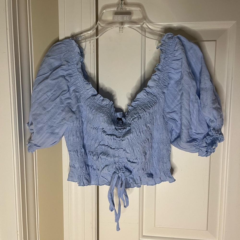 blue ruffled shirt